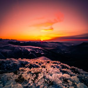 Preview wallpaper sunset, ice, grass, horizon, rocks