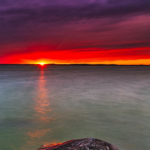 Preview wallpaper sunset, lake, horizon, stone, water