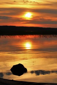 Preview wallpaper sunset, lake, sun, stones, reflection