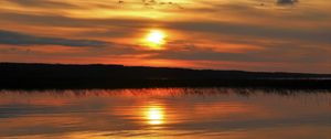 Preview wallpaper sunset, lake, sun, stones, reflection