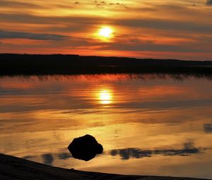 Preview wallpaper sunset, lake, sun, stones, reflection
