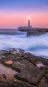 Preview wallpaper sunset, lighthouse, sea, surf, waves, stones, spain