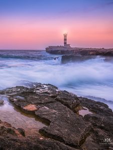 Preview wallpaper sunset, lighthouse, sea, surf, waves, stones, spain