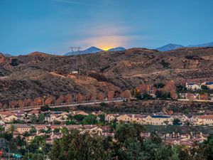 Preview wallpaper sunset, mountains, buildings, trees