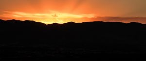 Preview wallpaper sunset, mountains, clouds, rays, dusk