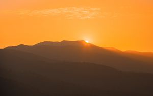Preview wallpaper sunset, mountains, distance, valley, sky