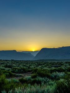 Preview wallpaper sunset, mountains, grass, distance