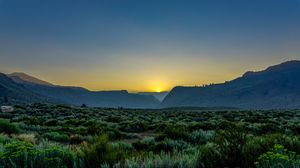 Preview wallpaper sunset, mountains, grass, distance