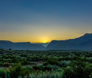 Preview wallpaper sunset, mountains, grass, distance