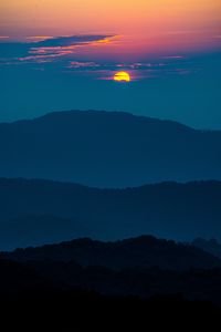 Preview wallpaper sunset, mountains, hills, clouds, dusk