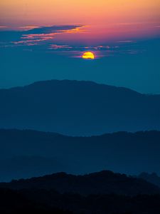 Preview wallpaper sunset, mountains, hills, clouds, dusk
