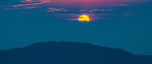 Preview wallpaper sunset, mountains, hills, clouds, dusk
