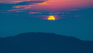 Preview wallpaper sunset, mountains, hills, clouds, dusk