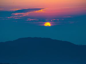 Preview wallpaper sunset, mountains, hills, clouds, dusk