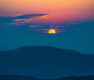 Preview wallpaper sunset, mountains, hills, clouds, dusk