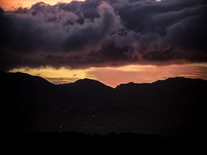 Preview wallpaper sunset, mountains, hills, sky, clouds