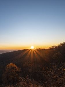 Preview wallpaper sunset, mountains, sun, rays, dusk