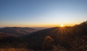 Preview wallpaper sunset, mountains, sun, rays, dusk