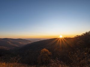 Preview wallpaper sunset, mountains, sun, rays, dusk