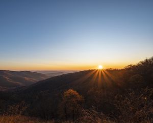 Preview wallpaper sunset, mountains, sun, rays, dusk