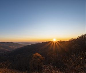 Preview wallpaper sunset, mountains, sun, rays, dusk