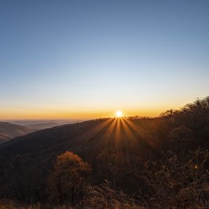 Preview wallpaper sunset, mountains, sun, rays, dusk