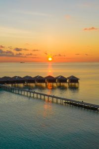 Preview wallpaper sunset, ocean, bungalow, sun, pier, beach vacation