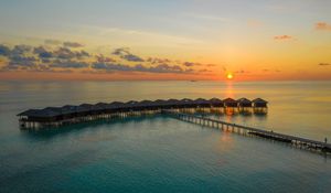 Preview wallpaper sunset, ocean, bungalow, sun, pier, beach vacation