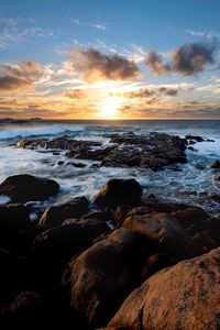 Preview wallpaper sunset, ocean, coast, stones, waves