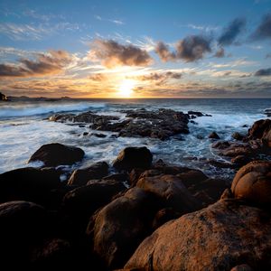 Preview wallpaper sunset, ocean, coast, stones, waves