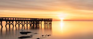 Preview wallpaper sunset, pier, horizon, stones, sea