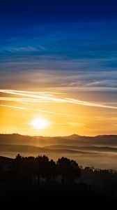 Preview wallpaper sunset, rays, hills, trees, sky
