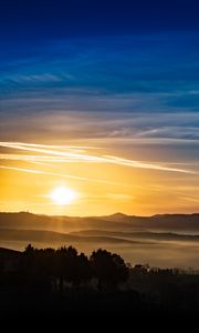 Preview wallpaper sunset, rays, hills, trees, sky