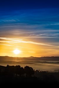 Preview wallpaper sunset, rays, hills, trees, sky