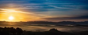 Preview wallpaper sunset, rays, hills, trees, sky