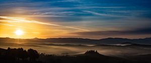 Preview wallpaper sunset, rays, hills, trees, sky