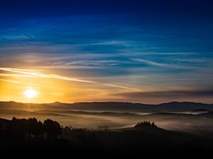 Preview wallpaper sunset, rays, hills, trees, sky
