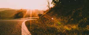 Preview wallpaper sunset, road, forest, grass, glare