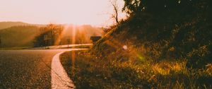 Preview wallpaper sunset, road, forest, grass, glare