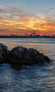 Preview wallpaper sunset, rocks, blocks, sea