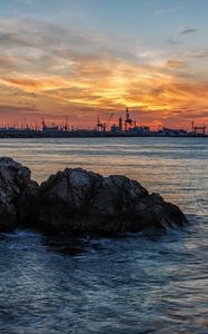 Preview wallpaper sunset, rocks, blocks, sea