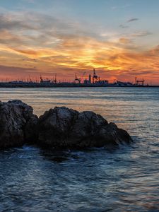 Preview wallpaper sunset, rocks, blocks, sea