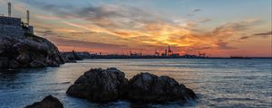 Preview wallpaper sunset, rocks, blocks, sea