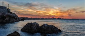 Preview wallpaper sunset, rocks, blocks, sea