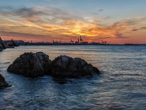 Preview wallpaper sunset, rocks, blocks, sea