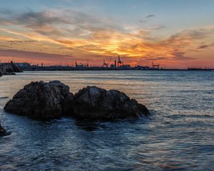 Preview wallpaper sunset, rocks, blocks, sea