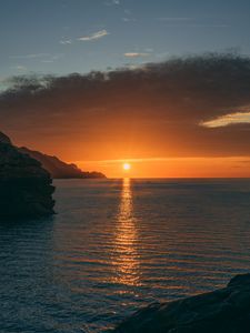 Preview wallpaper sunset, rocks, glare, sea, horizon