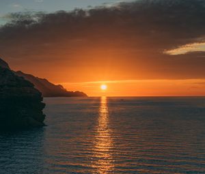 Preview wallpaper sunset, rocks, glare, sea, horizon