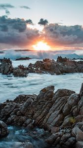 Preview wallpaper sunset, rocks, sea, stones, clouds