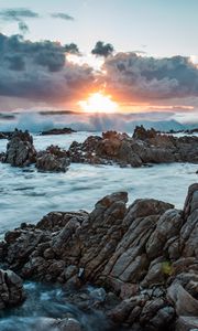 Preview wallpaper sunset, rocks, sea, stones, clouds